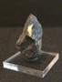 Uraninite - Deer Park Mine, North Carolina, USA  on acrylic mount indoor light