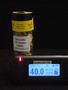 25 Grams of Autunite Fragments in a Glass Vial under normal light measured by the radiacode 102