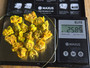 25 Grams of Autunite Fragments on scale