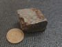 61 Gram Galena Crystal on display under indoor light - size comparison to copper penny