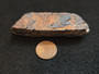 162 Gram Tantalite-(Fe) specimen  under indoor light size comparison to copper penny rear view