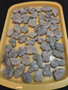 Trinitite Lot 1/4 lb 54 pieces, each smaller than 4 grams. on a yellow tray