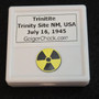showing how Trinitite (Atomic Bomb Glass), 790 Milligrams is stored in labeled display case Rear view