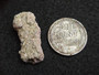 Trinitite (Atomic Bomb Glass), Trinity Site, New Mexico, July 16, 1945 - under indoor light size comparison to steel penny bottom view