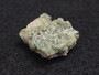 1.5 Gram Trinitite sample displayed under indoor light