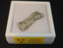 showing how this 1.3 Gram Trinitite sample displayed under indoor light in a labeled case bottom view