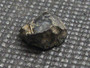 Uraninite  on display under indoor light