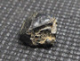 Uraninite  on display under indoor light