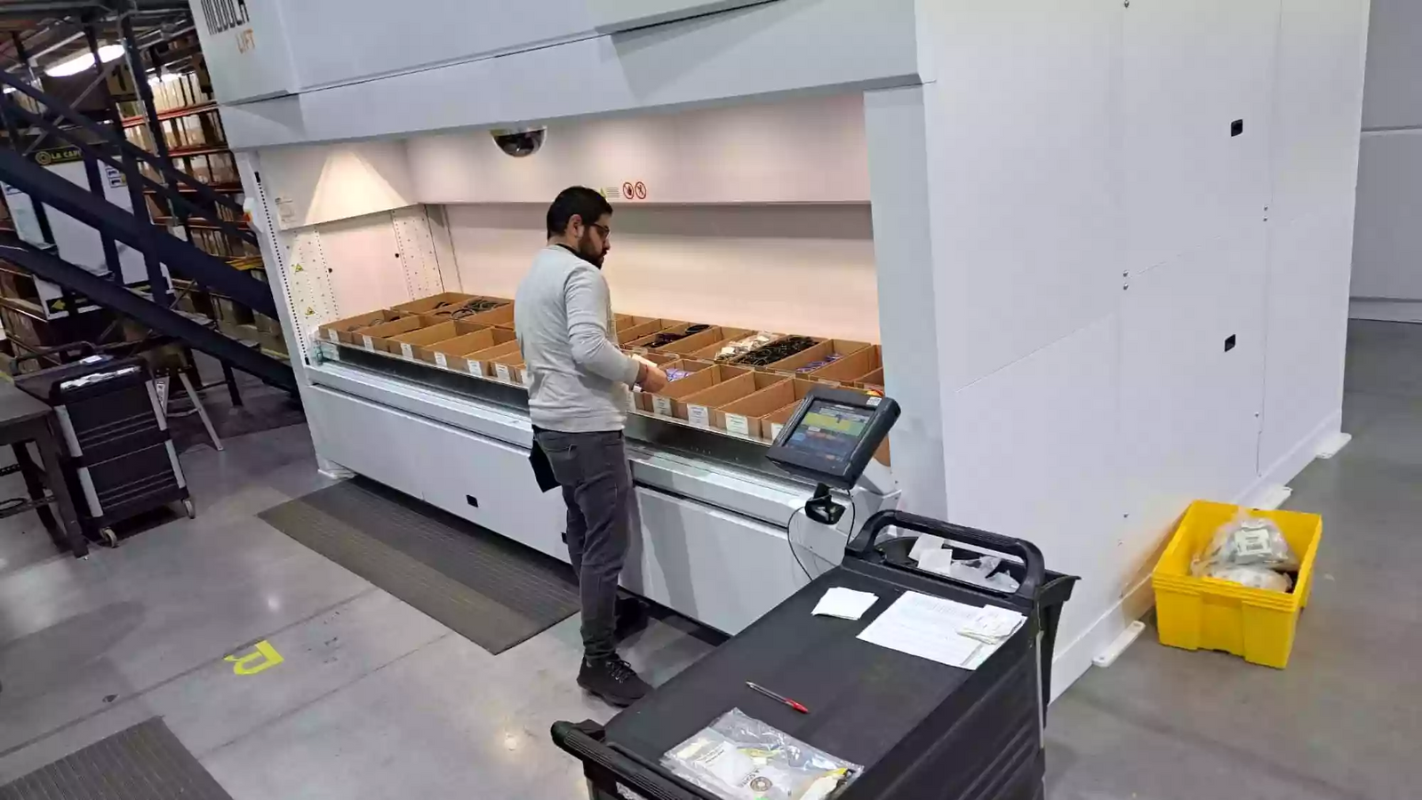 Verticle Lift Module system with an operator picking from trays