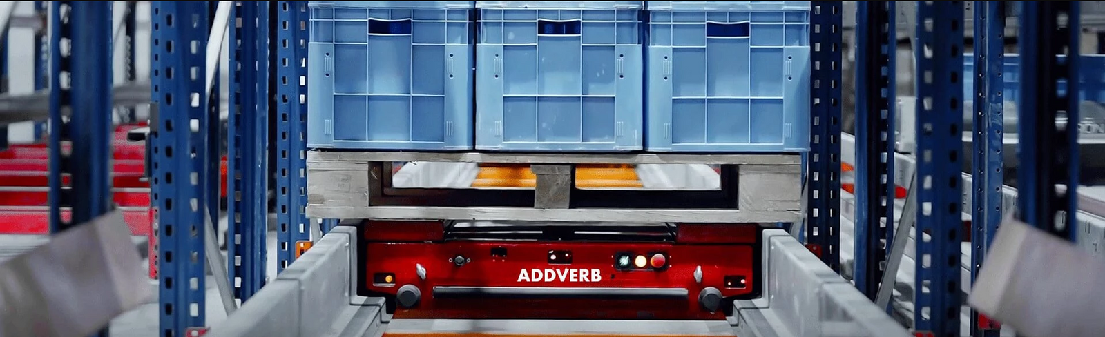 Pallet shuttle sits inside racking system ready to put away palletized goods