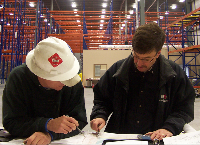Warehouse1 employee works with contractor on a warehouse installation project