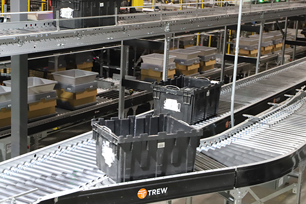 Trew MDR conveyors feeding bins through a warehouse