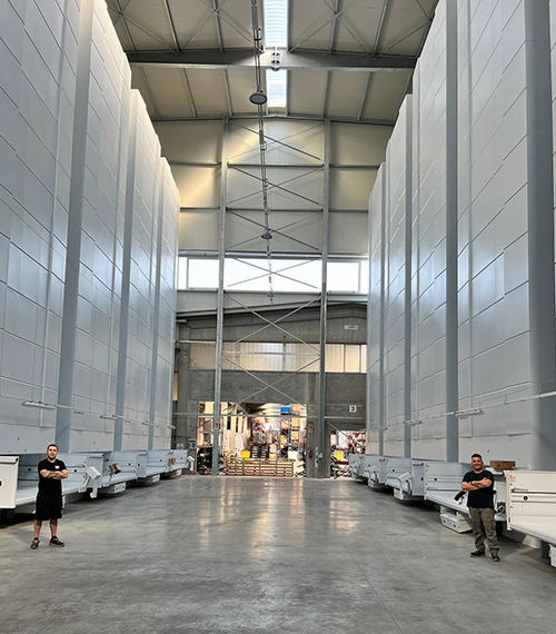 Two rows of vertical lift modules with two employees