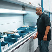 Employee picks from a vertical lift module