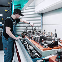 Technician inspects industrial parts inside VLM trays