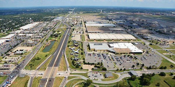 Line of warehouses and distribution centers on both sides of a highway.