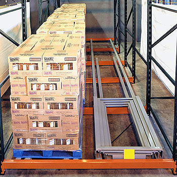 Line of pallets stored in a pushback system.