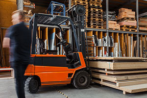 Forklift next to pallet racks in a warehouse