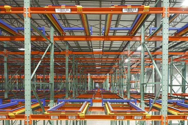 Image of large covered warehouse space filled from floor to ceiling with push back pallet racking.