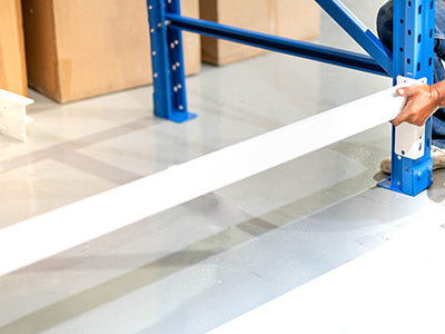 Image showcasing safe assembly of pallet racking and beams.