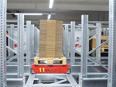Pallet shuttle with a loaded pallet inside a rack system