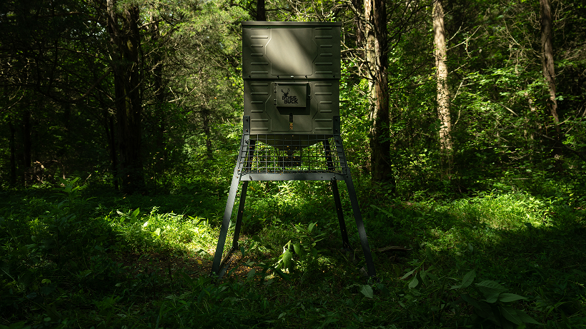 Elevated tripod deer feeder in the timber set up to keep hogs out