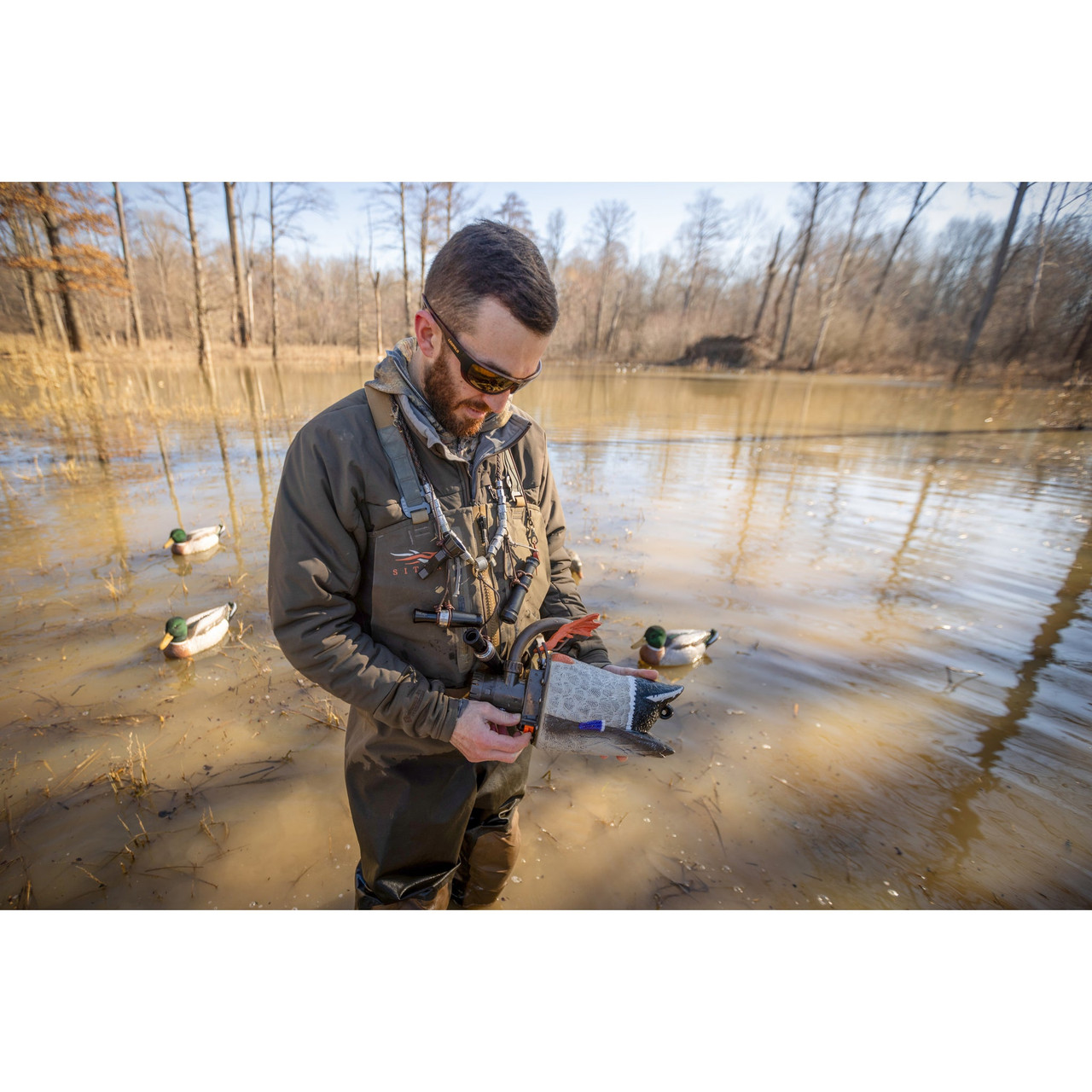 Hunter holding a Higdon Pulsator PRO in flooded timber