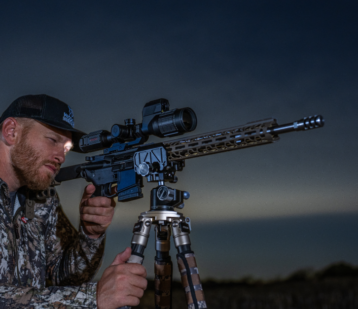 Hunter looking through Athlon Optics Scope