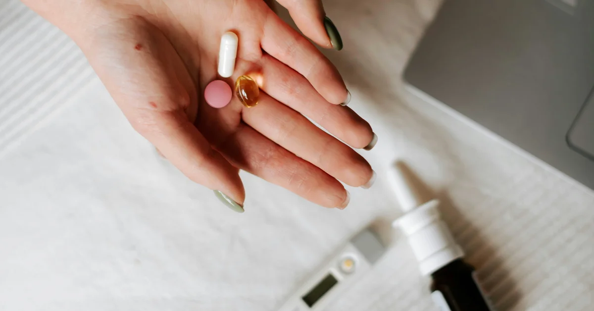Myo-inositol for fertility Woman reviewing a supplement bottle beside her laptop, researching myo-inositol for PCOS and fertility support.
