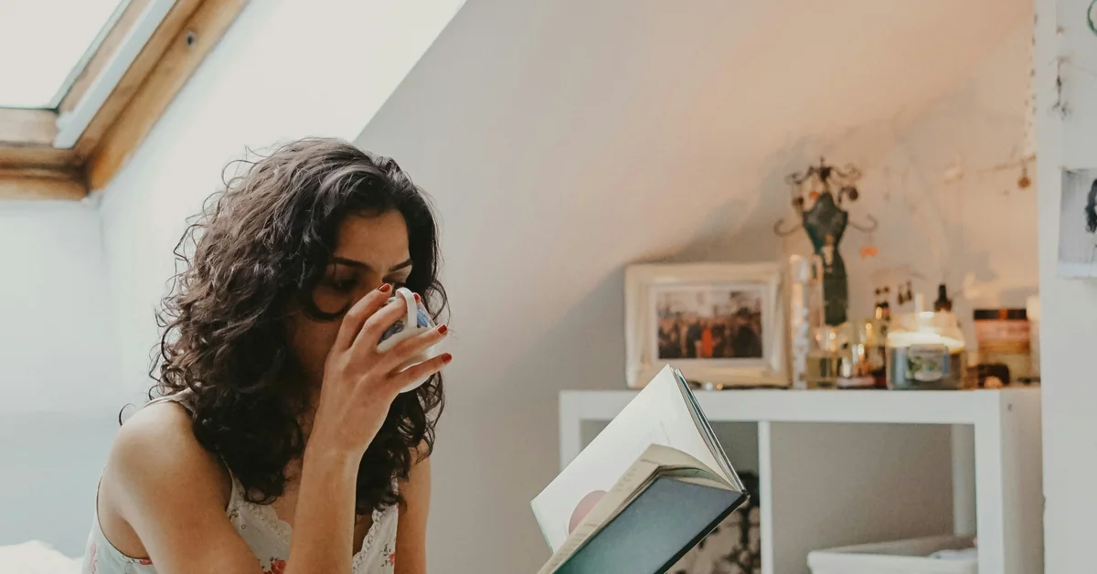 Woman in warm natural light, hand resting thoughtfully, expressing calm empowerment on her PCOS fertility journey.