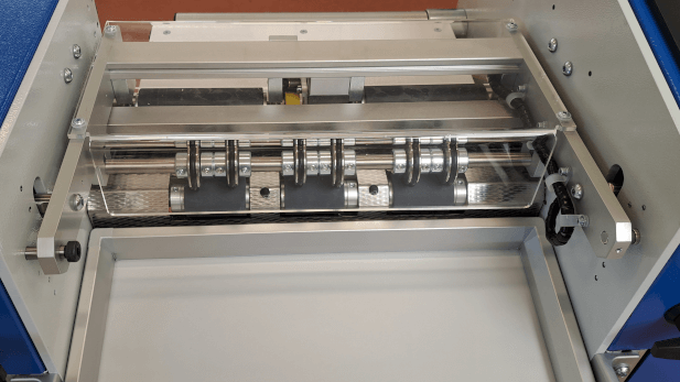 Pull rollers feeding the web on the ZFP mini roll-to-sheet cutter