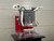 Side detail of the InnoPrinter MK2 heat press showing the laser alignment sensor, media path, and mid-size heated platen over the pin positioning table