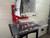 InnoPrinter MK3 roll-to-roll semi-automatic heat press mounted on a clear pin positioning table for fast, repeatable garment placement