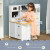 HOMCOM Kids Kitchen Playset, Large Pretend Role Play Kitchen, White lifestyle with child showing side