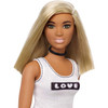 Barbie doll's blonde hair is styled with a trendy blunt cut.