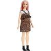 Barbie doll wears an off-the-shoulder cream shirt under an animal print dress with peplum.