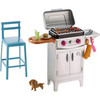 Summery themes set the scene for a perfect day outside — like this silvery grill and tall blue stool.