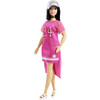 Barbie doll is sporty chic in a pink jersey-inspired dress with uneven hem, striped accents and team number; white platform shoes are fun; and her black hair is styled in a modern straight style.