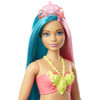 A bright headpiece in her long, teal and pink hair adds another burst of colour.