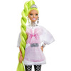 Barbie doll rocks star-printed makeup, and extra-long, neon-green hair styled in a glam twisted ponytail.