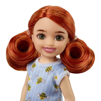 Chelsea doll's red hair is styled in sweet pigtails, and blue sandals complete her look.