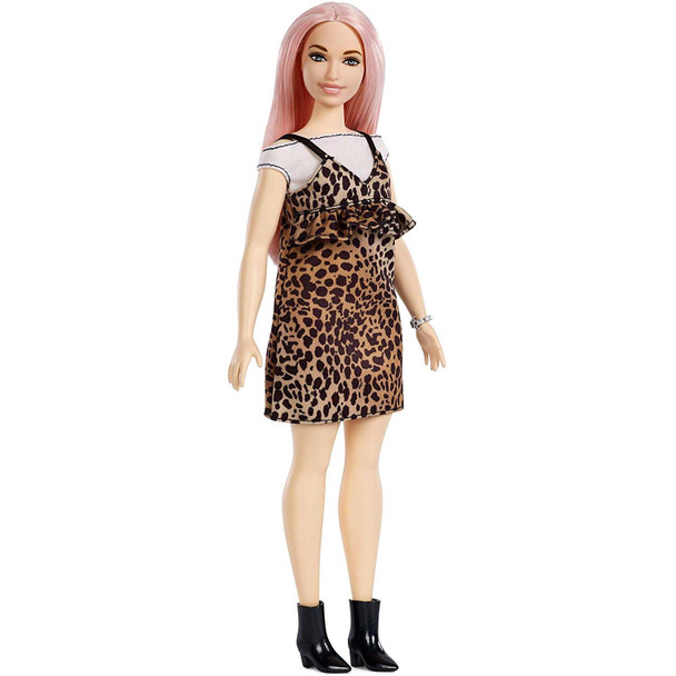 Barbie doll wears an off-the-shoulder cream shirt under an animal print dress with peplum.