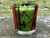 Tree of Life Printed Glass Candle Holder for votive candles displayed on a rock highlighting the dragonfly details, hand-printed colorful glass tealight holder with Celtic knot design, decorative votive candle cup, candle not included.