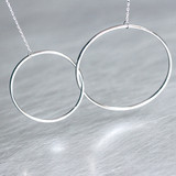 Sterling Silver Outline Circle Knot Necklace White Gold from kellinsilver.com