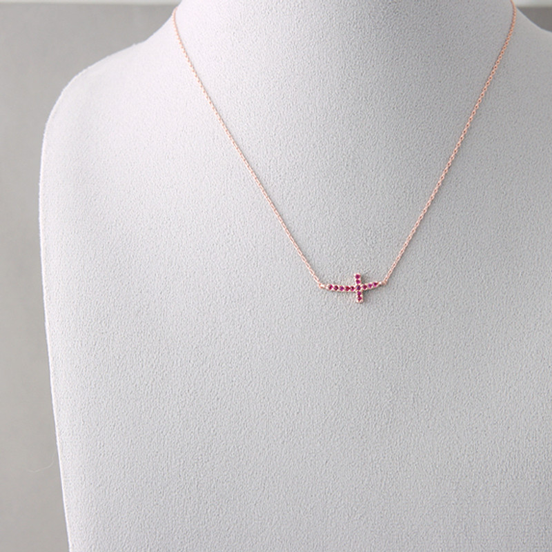 Ruby Swarovski Rose Gold Curved Sideways Cross necklace