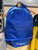 Yamaha Essentials Backpack in blue, 38-litre motorcycle and everyday backpack with padded back and straps, main compartment, side zip pockets, outer mesh pockets, shoe compartment and Yamaha branding.