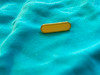 Vintage yellow enamel safety pin brooch "Only one available" 7/8th of an inch long by a quarter inch wide