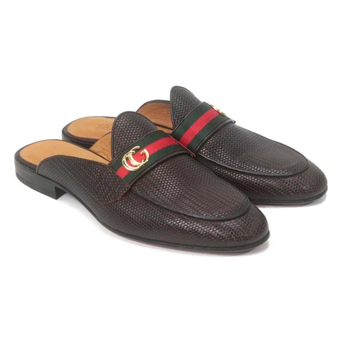 Close-up of double-tone buckle and side cut paneling on brown slip-on shoe