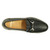 Top-down view of the Snaffle loafer's moc-toe seam and bit hardware in black sheepskin