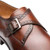 Mezlan Forest cognac monk strap shoe, close-up of buckle and wingtip toe cap